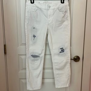 White House Black Market white straight-leg jeans with blue knee cutouts